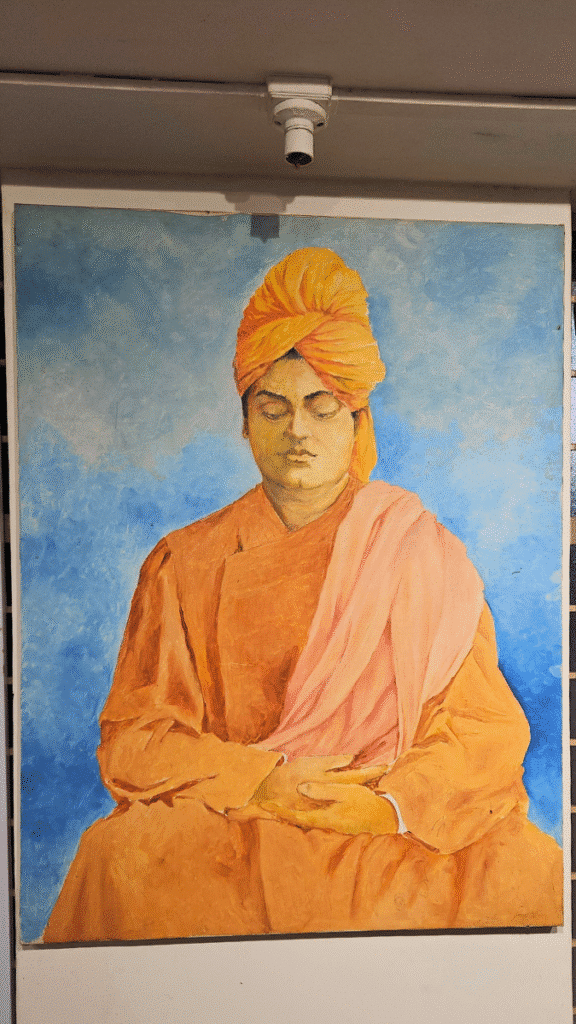 An unfinished painting of Swami Vivekananda by N.C. Desai, notable for its missing signature, symbolizing the artist’s final incomplete work, displayed at the Hubballi Art Exhibition.